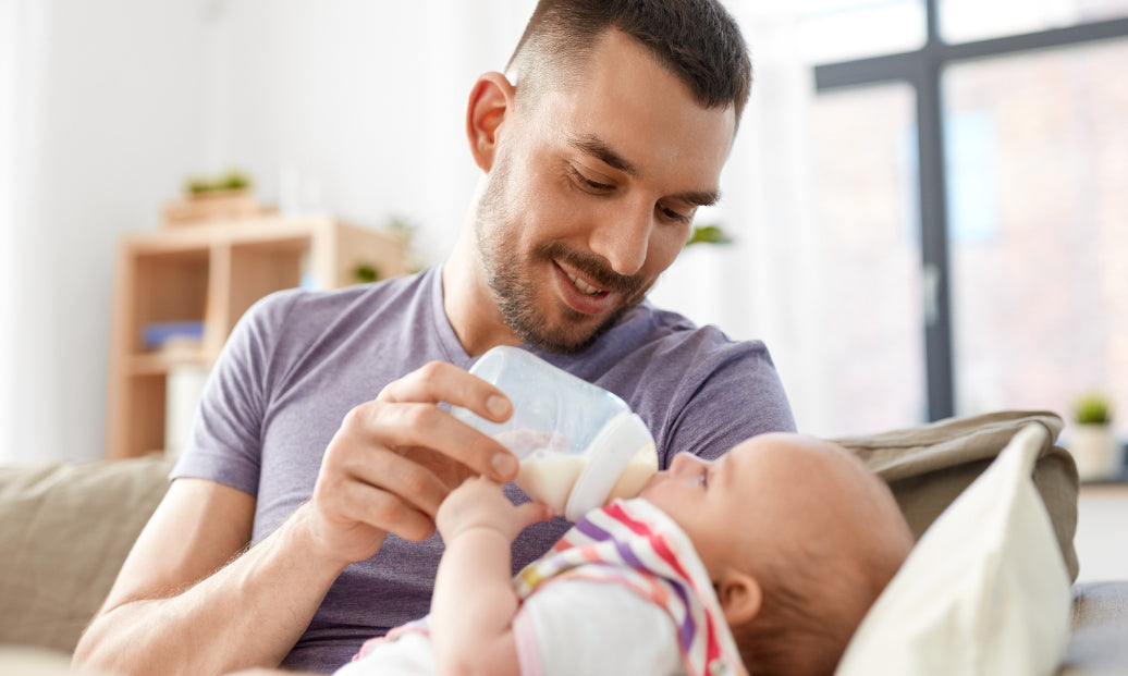 Father feeding a baby from a bottle