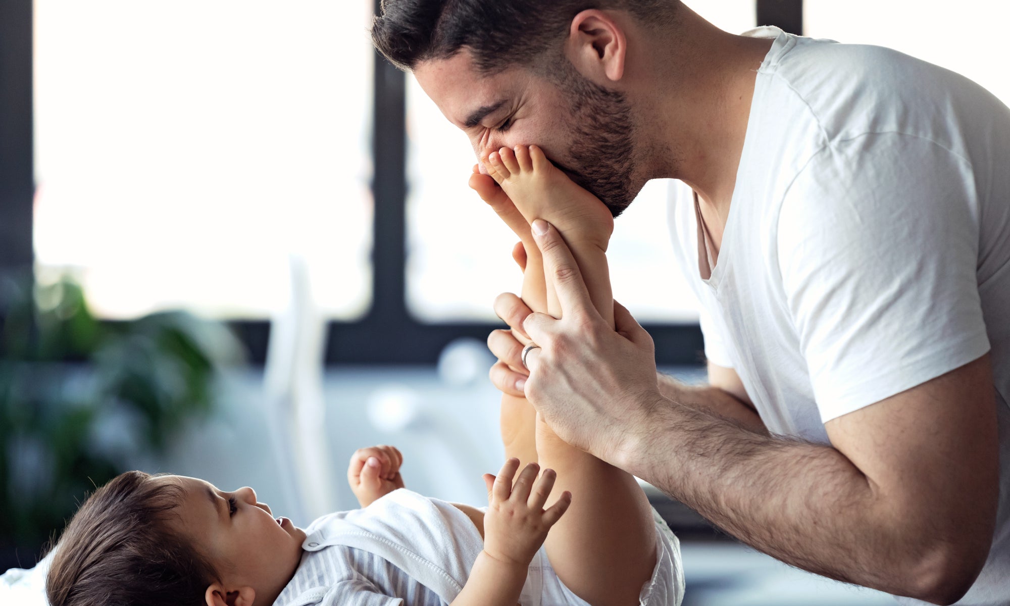 A baby in a nappy with parent