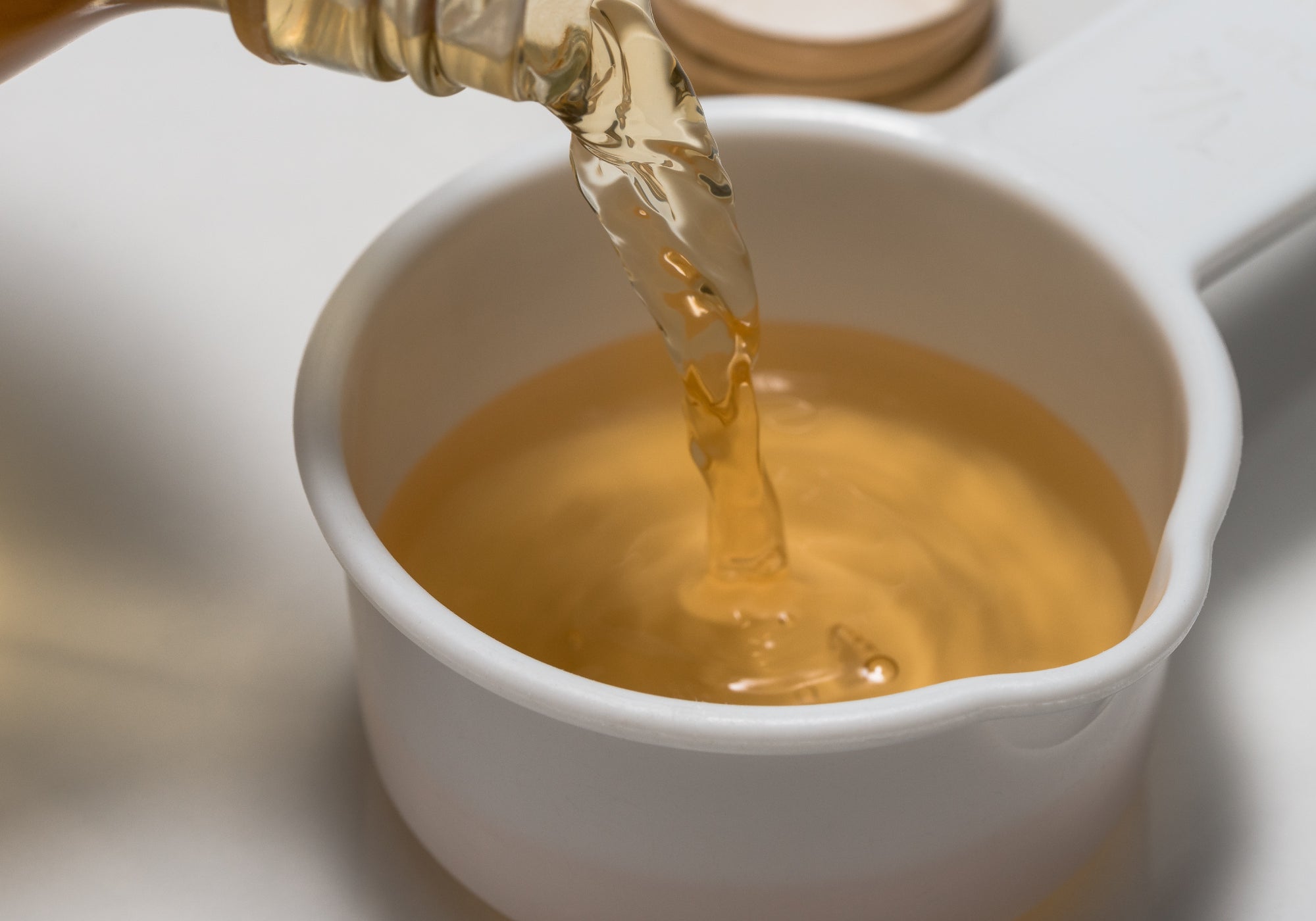 Apple Cider Vinegar pouring into a small bowl