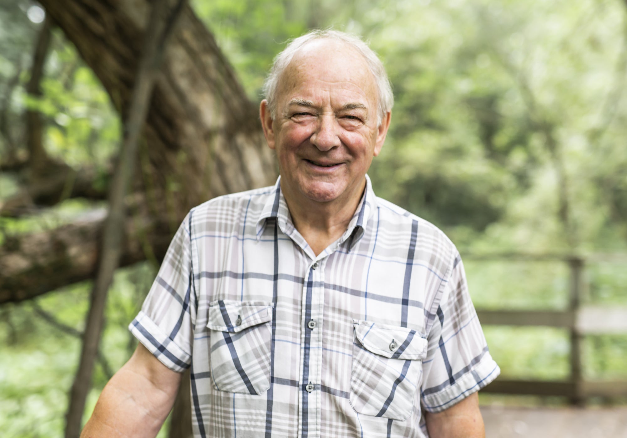 Man in checked shirt walking in countryside