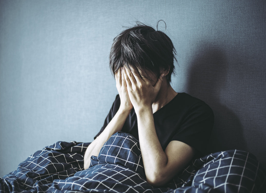 Distressed person sitting up in bed