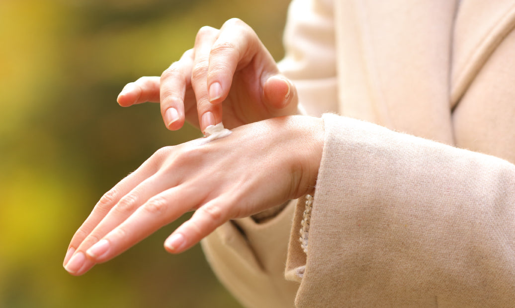 Rubbing cream into the back of a hand on a cold winter day