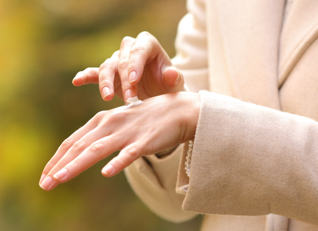 Rubbing cream into the back of a hand on a cold winter day