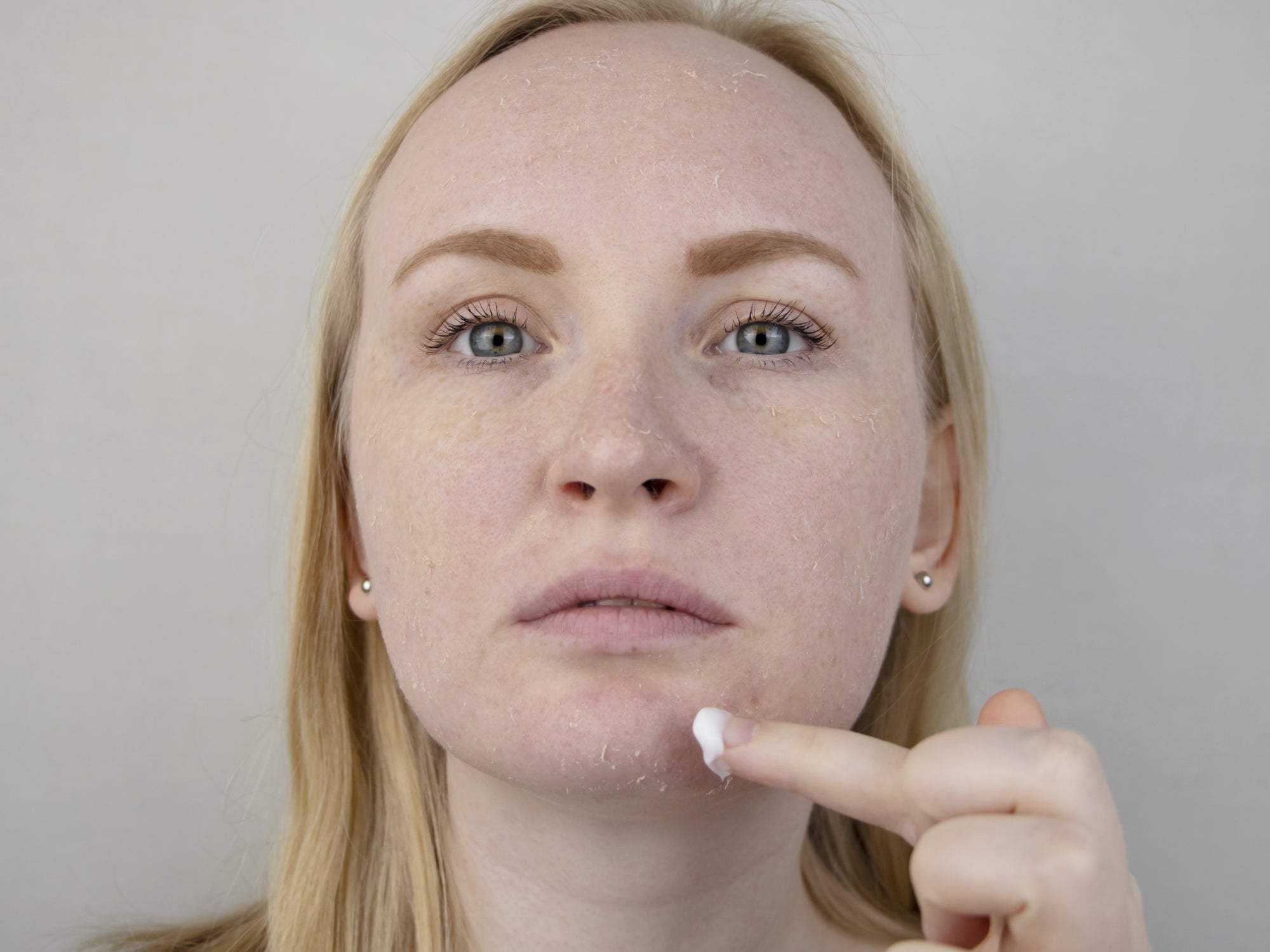 Applying cream to face