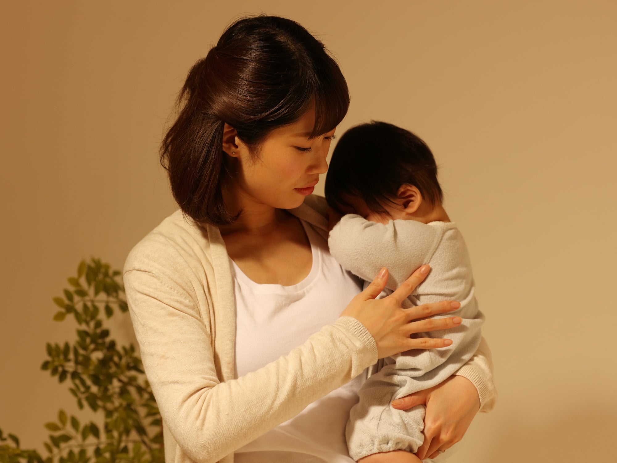 A mother holding a tired baby